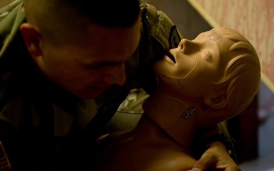Pfc. Luis Pena inspects a simulated casualty during a demonstration for Ukrainian Army physicians in Baumholder, Germany, on Thursday, July 21, 2016.
