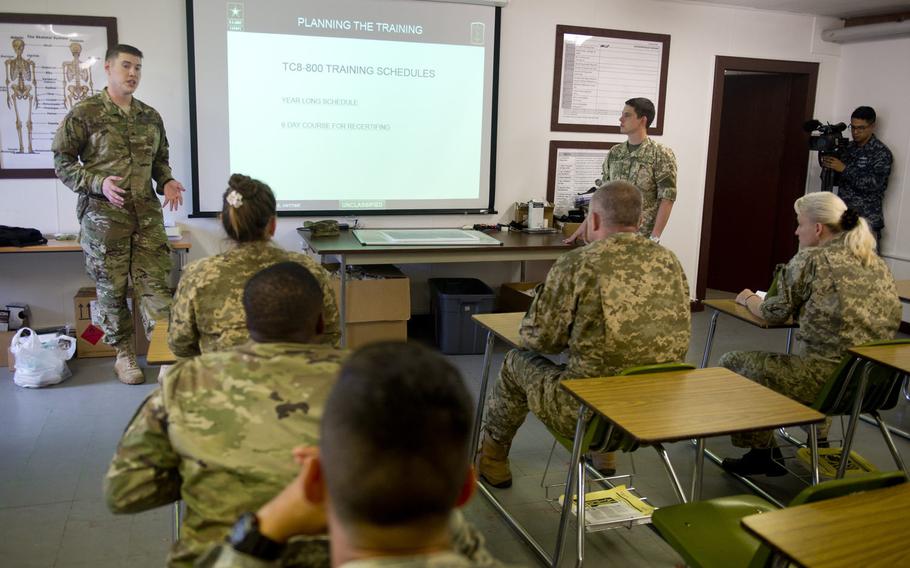Sgt. Troy Wruk, from the 421st Multipurpose Medical Battalion, discusses medic training schedules with Ukrainian Army physicians in Baumholder, Germany, on Thursday, July 21, 2016. The presentation was part of a medical sustainment class designed to teach unit-level processes for maintaining a military medic's proficiency used by the U.S. Army, and a model for the Ukrainian combat medic program.