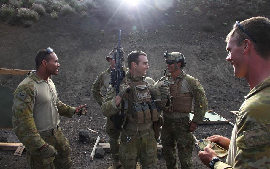 Australian soldiers share a laugh during a rifle marksmanship contest with U.S. Marines at Pohakuloa Training Area, Hawaii, during RIMPAC 2016.