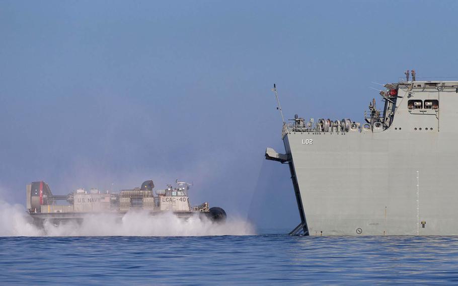 A U.S. Navy landing craft, air cushion from amphibious transport dock USS San Diego enters the well dock of the HMAS Canberra off the coast of Hawaii during the Rim of the Pacific exercise, July 19, 2016.