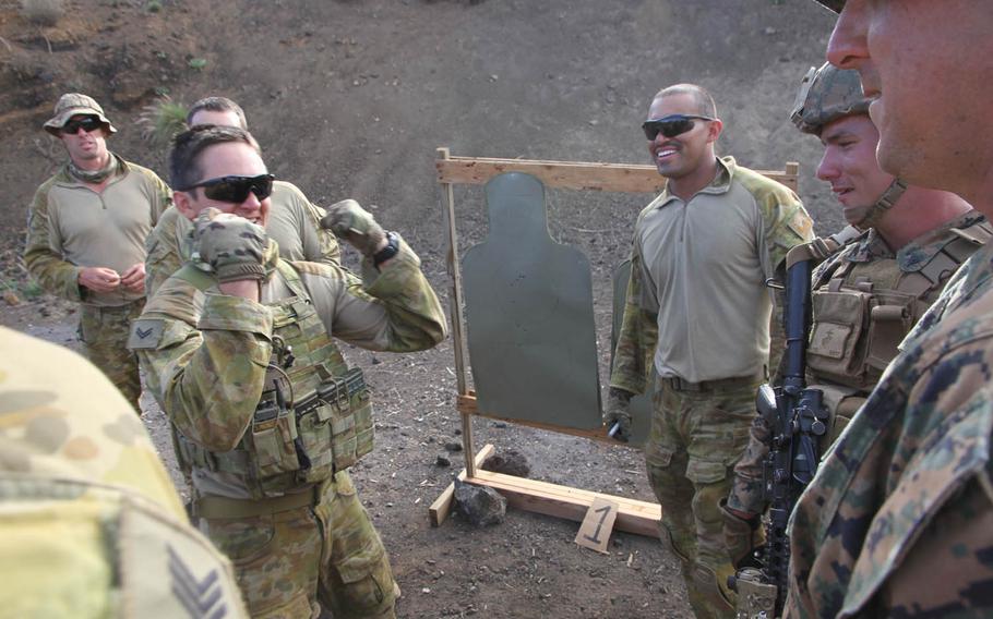 An Australian soldier celebrates his team's victory in the first round of a rifle competition against U.S. Marines at Pohakuloa Training Area, Hawaii, during RIMPAC 2016.