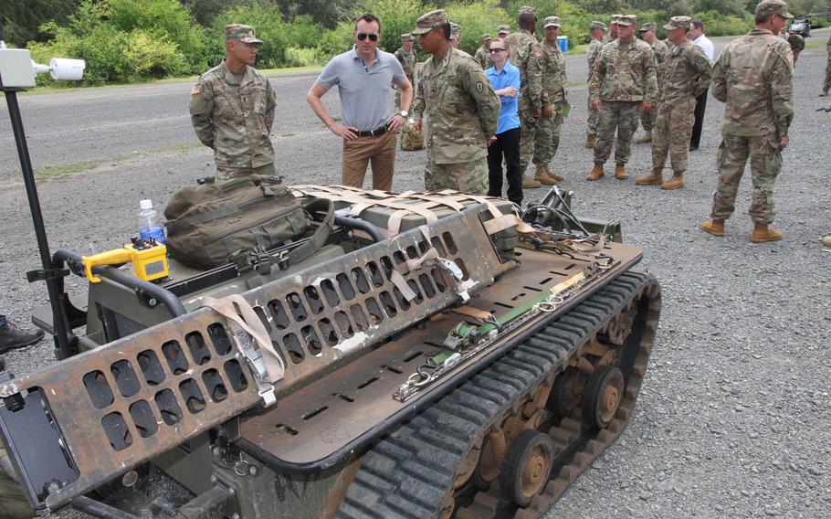 Secretary of the Army Eric K. Fanning talks with soldiers about a robotic device during a demonstration at Bellows Air Force Station, Hawaii, Tuesday, July 26, 2016. Fanning kicked off his first tour of the Pacific Tuesday with demonstrations of the service's high-tech and basic jungle know-how.