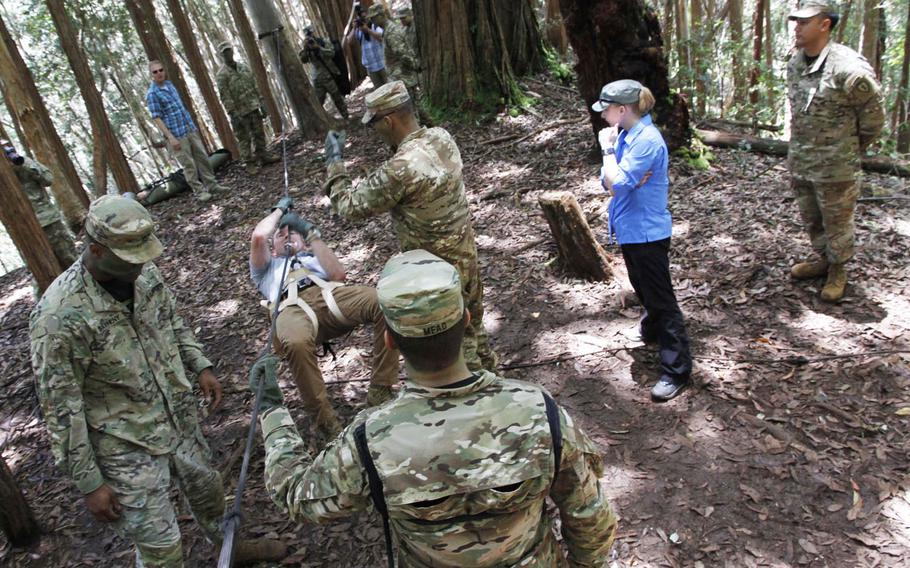 During a tour of the 25th Infantry Division's Lighting Academy jungle training in Hawaii on Tuesday, July 26, 2016, Secretary of the Army Eric K. Fanning tests his skill at crossing a span via rope.