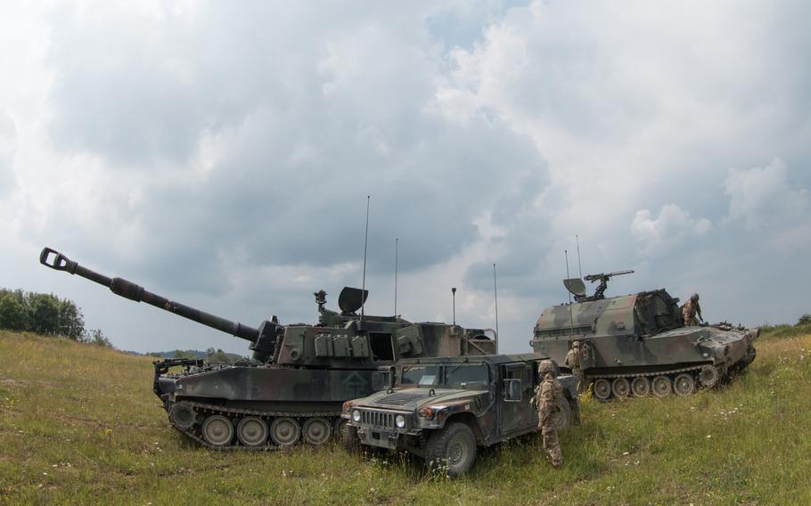 Soldiers with Alpha Battery, 1st Battalion, 41st Field Artillery Regiment, prepare to fire at a range in Vilseck, Germany, on Tuesday, July 26, 2016.