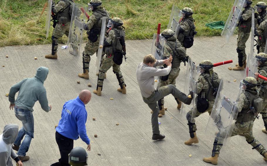 Soldiers of the Kazakh Peacekeeping Battalion suppress rioters during Exercise Steppe Eagle, Thursday, July 28, 2016. The 13th annual training event brought together 798 soldiers from the United Kingdom, United States, Kazakhstan, Tajikistan and Kyrgyzstan to train in peacekeeping operations.