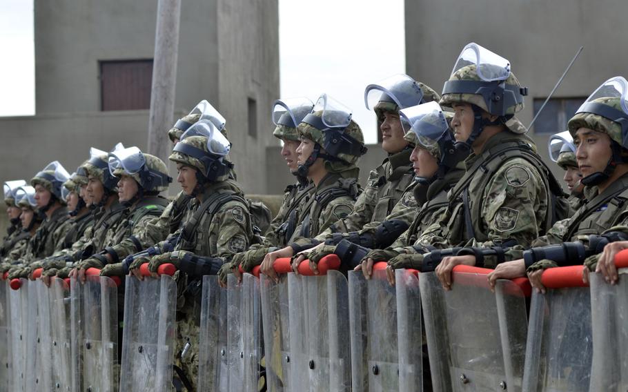 Soldiers of the Kazakh Peacekeeping Battalion secure a village street during Exercise Steppe Eagle, Thursday, July 28, 2016.