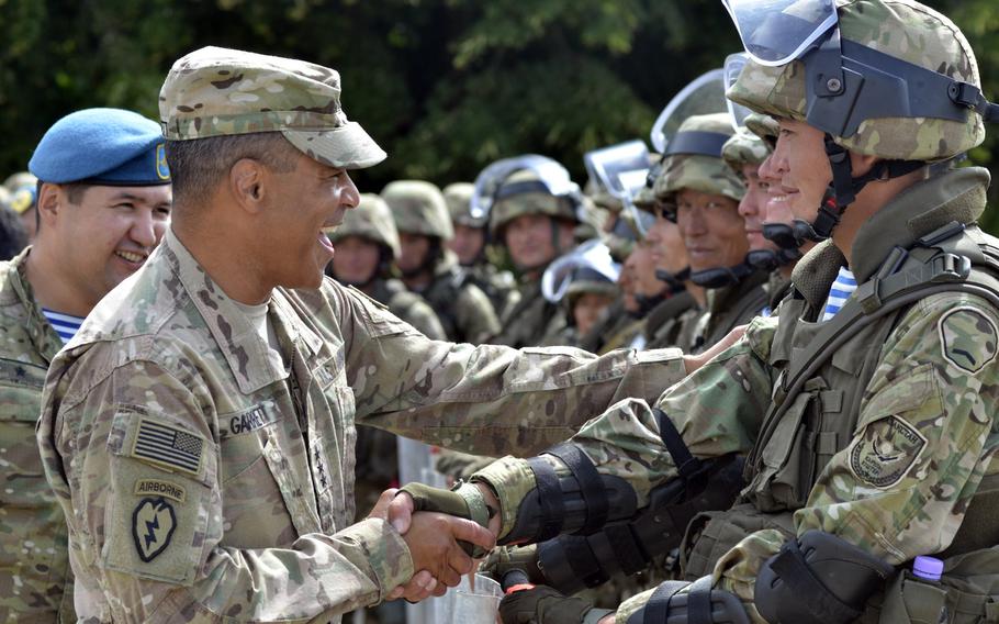 Lt. Gen. Michael X. Garrett, commander, U.S. Army Central congratulates soldiers of the Kazakh Peacekeeping Battalion on their success during Exercise Steppe Eagle, July 28, 2016. The 13th annual training event brought together 798 soldiers from the United Kingdom, United States, Kazakhstan, Tajikistan and Kyrgyzstan to train in peacekeeping operations.