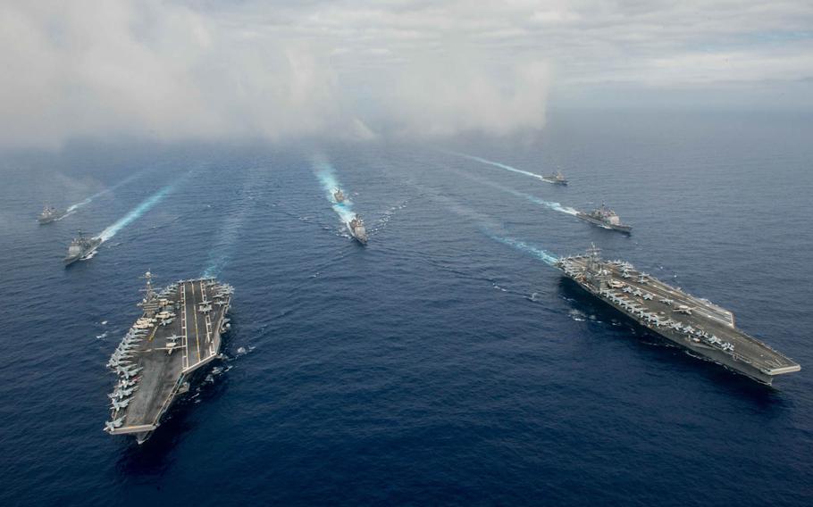 The Nimitz-class aircraft carriers USS John C. Stennis, left, and USS Ronald Reagan conduct carrier strike group operations in the Philippine Sea on July 17, 2016.