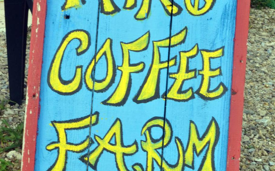 A hand-crafted sign welcomes customers to Hiro Coffee Farm in Okinawa, Japan.