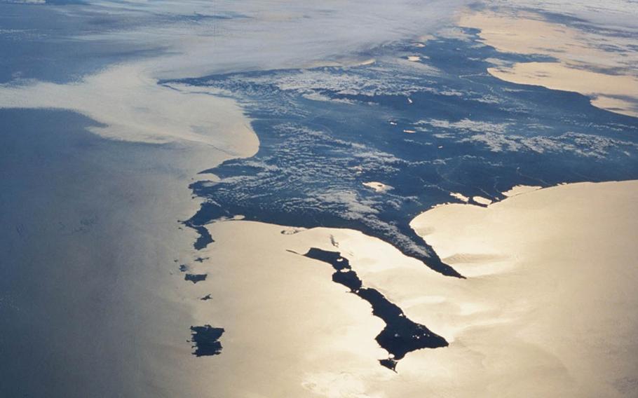 This undated NASA photo taken from space shuttle Endeavor shows the large Japanese island of Hokkaido, background, and several Russian-controlled smaller islands, including Kunashiri, front right, Shikotan, front left, and the Habomai rocks. Japanese Prime Minister Shinzo Abe is seeking the return of the islands, which were seized by Russia in the final days of World War II.