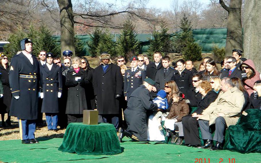Debbie Venetz receives a folded flag at the funeral of her husban Sgt. 1st Class Anthony Venetz at Arlington National Cemetery on Feb. 10, 2011. 