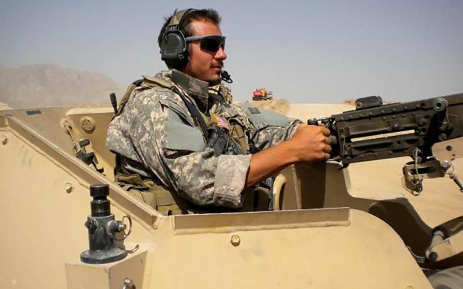 Sgt. 1st Class Anthony Venetz operates a meachine gun atop a vehicle in Afghanistan in 2009. 