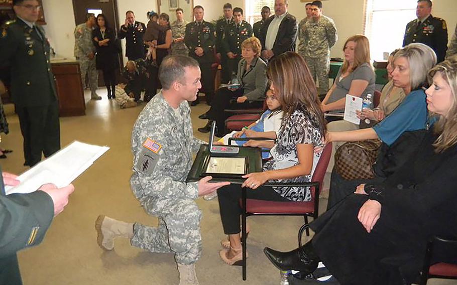 Recently widowed, Debbie Venetz receives a Meritorious Service Medal on behalf of her late husband Sgt. 1st Class Anthony Venetz at Fort Bragg in North Carolina in February 2011, just weeks after his death in Afghanistan. The circumsntances of his death would later be called into question.
                Photo courtesy of Debbie Venetz