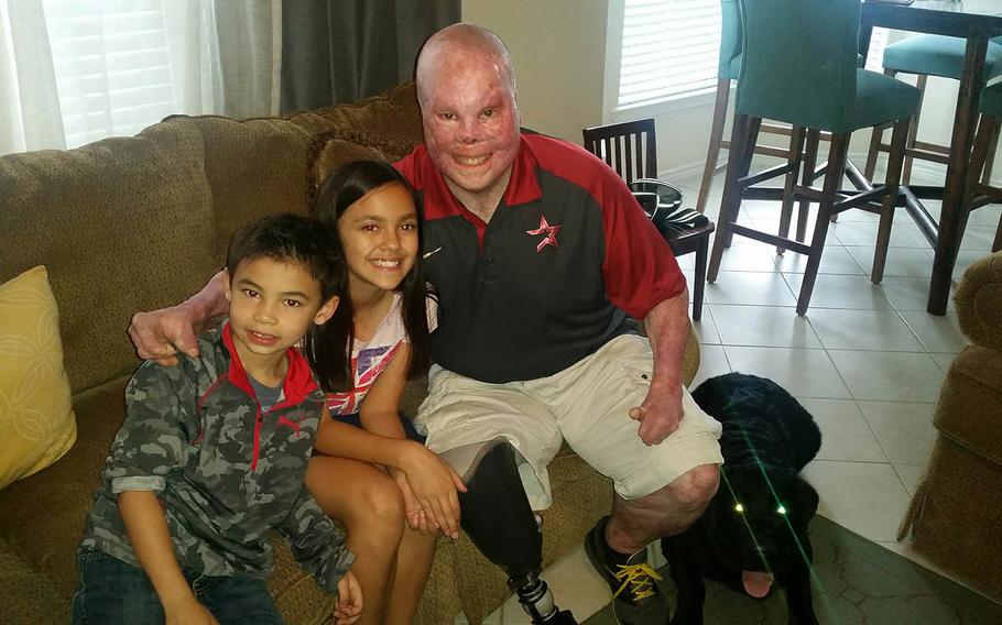 Jace Venetz, 8, left and Alexa Venetz, 12, whose father Anthony Venetz died in Afghanistan in 2011, visit with Rick Yarosh. Anthony and another soldier pulled Yarosh from a burning vehicle in Iraq in 2006.