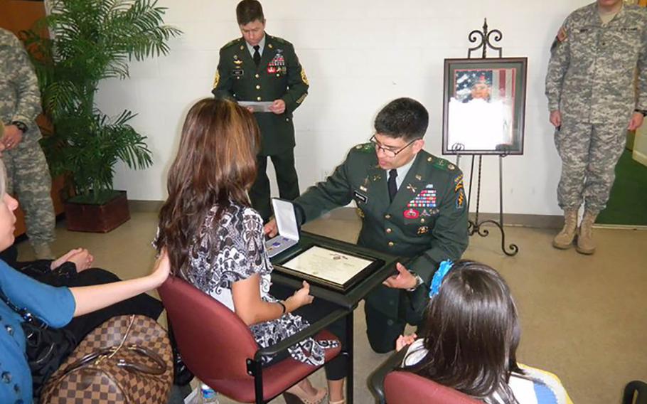 Debbie Venetz receives a Purple Heart on behalf of her late husband Sgt. 1st Class Anthony Venetz in February 2011, just weeks after his death in Afghanistan. The circumstances of his death would later be called into question.