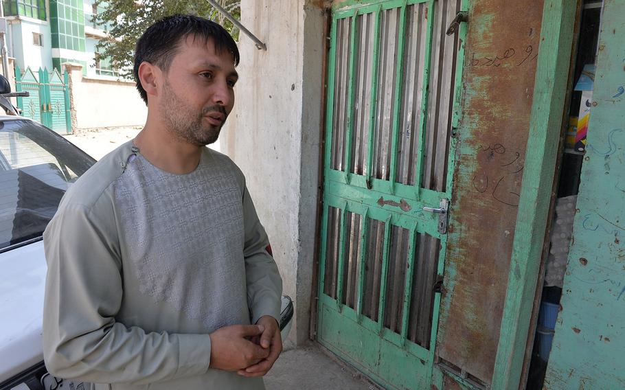 Ahmed Jawad Sekandari, pictured here on Aug. 17, 2016, standing near the corner store where his son was killed by flying debris during a January suicide bombing. He said he fears a worsening security situation in Afghanistan. Insurgent violence has taken a human and economic toll on his family.