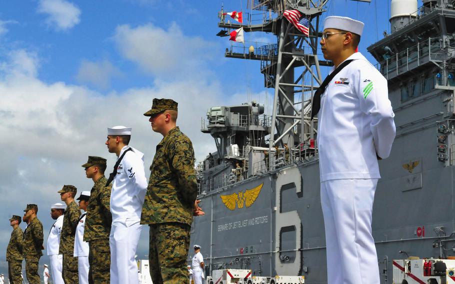 Sailors and Marines aboard the amphibious assault ship USS Bonhomme Richard man the rails in this file photo from February 21, 2012. Navy officials in Japan have issued "several Okinawa-specific provisions" to an updated liberty policy to ensure Navy and Marine Corps guidance is consistent.