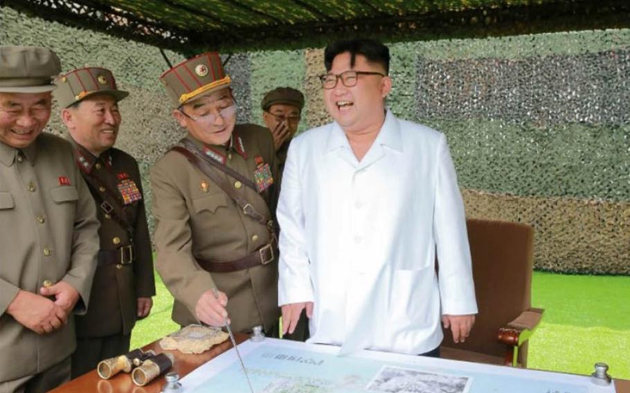North Korean leader Kim Jong Un smiles as one of his generals points to a strategic map. The photo appeared on the front page of the official newspaper Rodong Sinmun on Sept. 6, 2016, with a story about a triple missile test the day before. Kim guided the launch and "expressed great satisfaction" at its success, the report said.