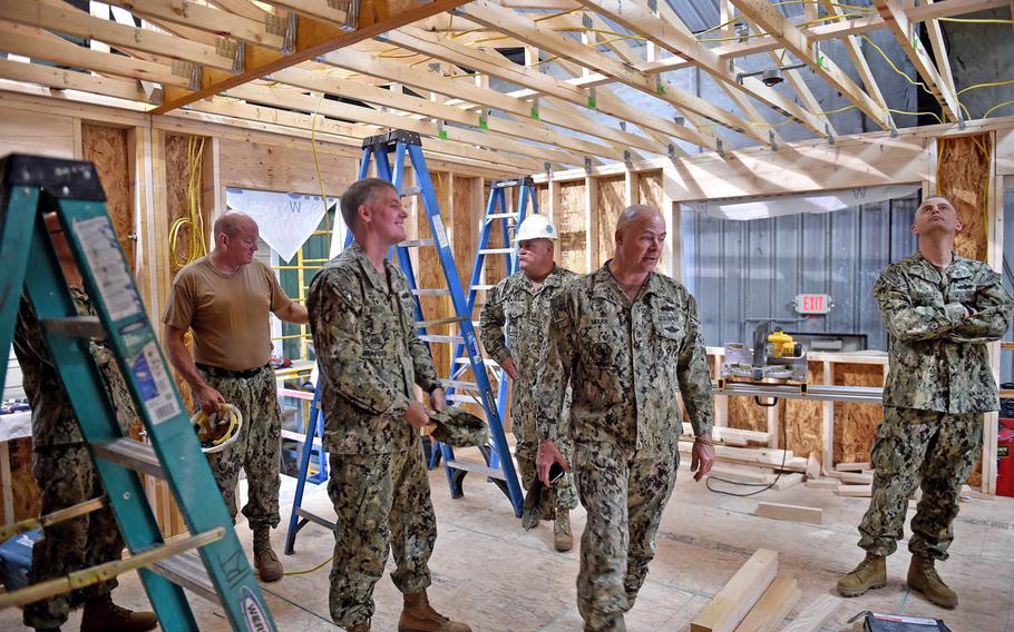 Capt. Steven Kelley, commodore of the 1st Naval Construction Regiment, and Seabees from Naval Mobile Construction Battalion 22 tour a home under construction at the Southwest Indian Foundation in Gallup, N.M., Aug. 26, 2016. Seabees are building homes for Navajo families under the Department of Defense Innovative Readiness Training program.