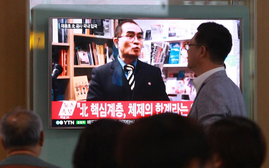People watch a news program showing a file image of Thae Yong Ho, a minister at the North Korean Embassy in London who defected, at Seoul Railway Station in Seoul, South Korea in August 2016. The high-profile defection is part of a growing trend of people fleeing to the South this year, according to government statistics released Wednesday.