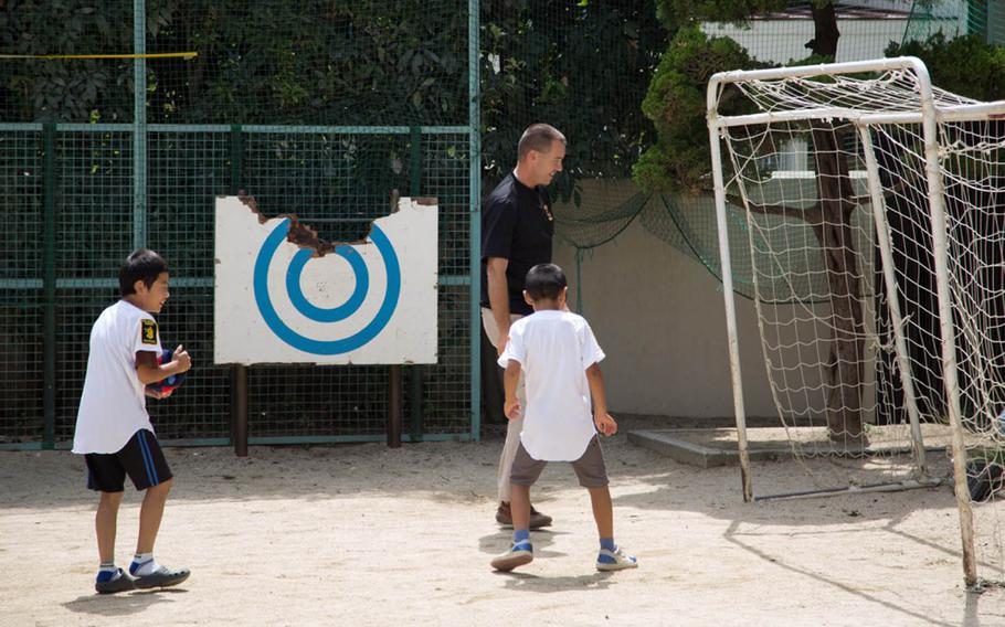 Maj. Scott Kennaugh, a chaplain with the 3rd Brigade Combat Team, 25th Infantry Division, plays soccer with children from the Holy Family Home orphanage in Osaka, Japan, Saturday, Sept. 10, 2016.