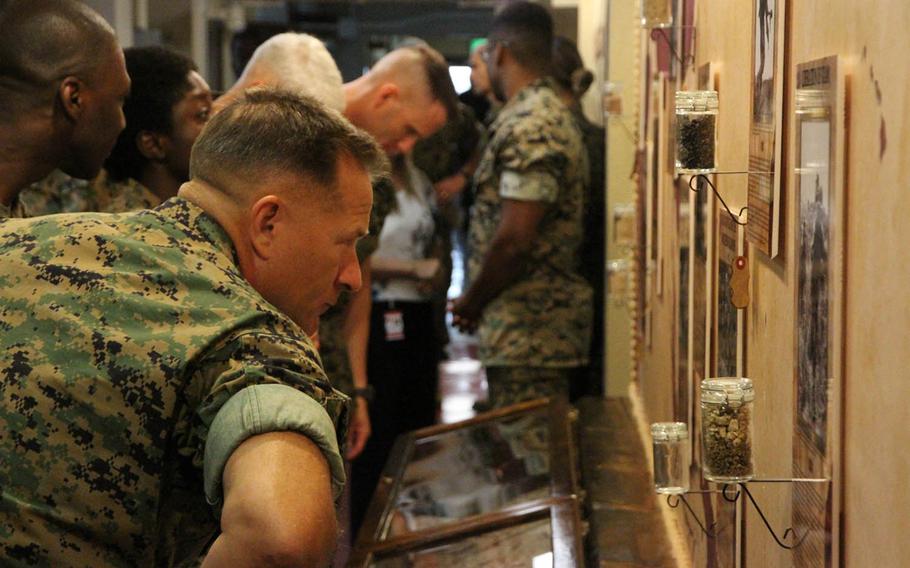 Marines check out a new historical display unveiled Friday, Sept. 16, 2016, inside 3rd Marine Division headquarters at Camp Courtney, Okinawa. The unveiling coincided with the division's 74th anniversary.