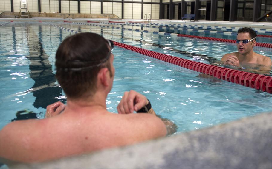 Air Force Maj. Casey Bowen, left, and Maj. Simon Ritchie discuss swim timing and coordination to build their endurance for the English Channel swim challenge in September 2016. The English Channel is about 21 miles of cold water. They could face gusting wind and waves up to 6.5 feet. Bowen and Ritchie are dermatologists with the 59th Medical Operations Group.