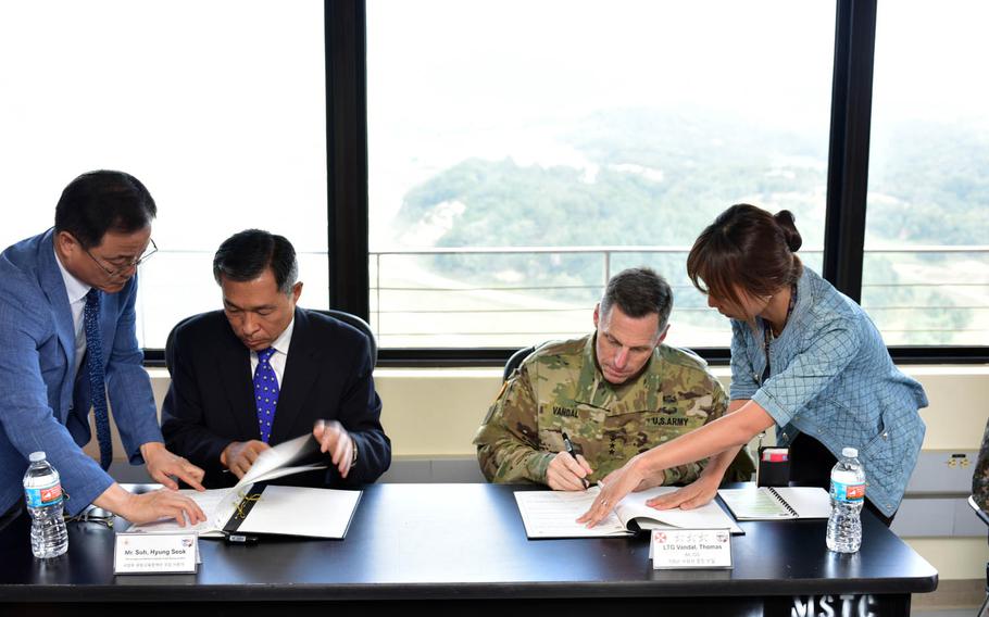 Suh Hyung-suk, an official with South Korea's Ministry of Defense, and Lt. Gen. Thomas Vandal, commander of the 8th Army, sign a memorandum of understanding at the Rodriguez Live Fire Complex near the border with North Korea on Thursday, Sept. 22, 2016.