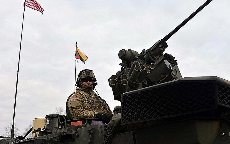 Spc. Bogdan Tkachuk of Lightning Troop, 3rd Squadron, 2nd Calvary Regiment sits in his Stryker in Alytus, Lithuania, on Monday, March 23, 2015, before his unit began its convoy back to Germany htrough Lithuania, Poland and the Czech Republic as part of an operation dubbed Dragoon Ride. The unit had been training in Lithuania. The exercise was conducted as a show of solidarity and support for Eastern European NATO allies in the wake of Russia's intervention in Ukraine.