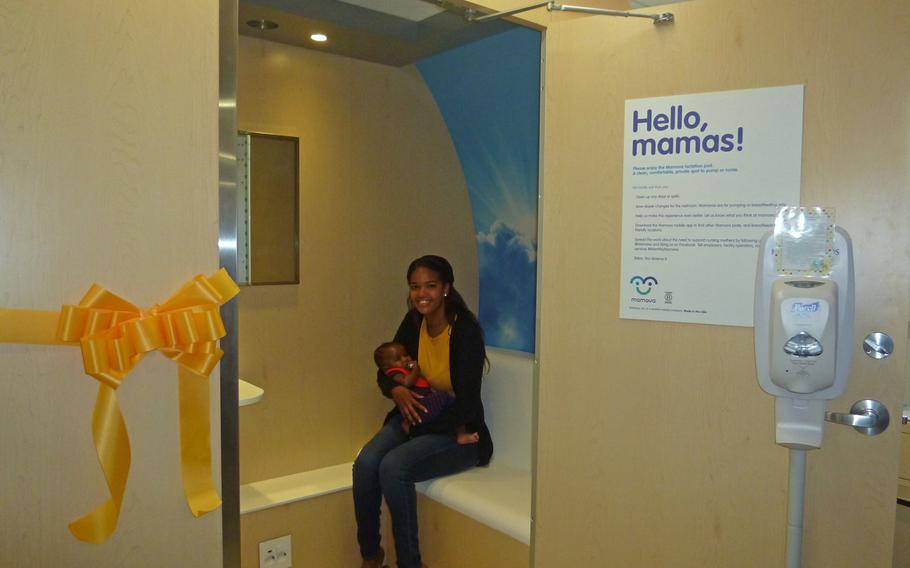 Cpt. Amatul Davis, labor and delivery nurse at Landstuhl Regional Medical Center holds her son Sept. 15, 2016, in the new Lactation Support Pod following a ribbon cutting ceremony. ''I work here and I also delivered my son here,'' Davis said. ''This new space is great because it is right in the middle of the hospital.''