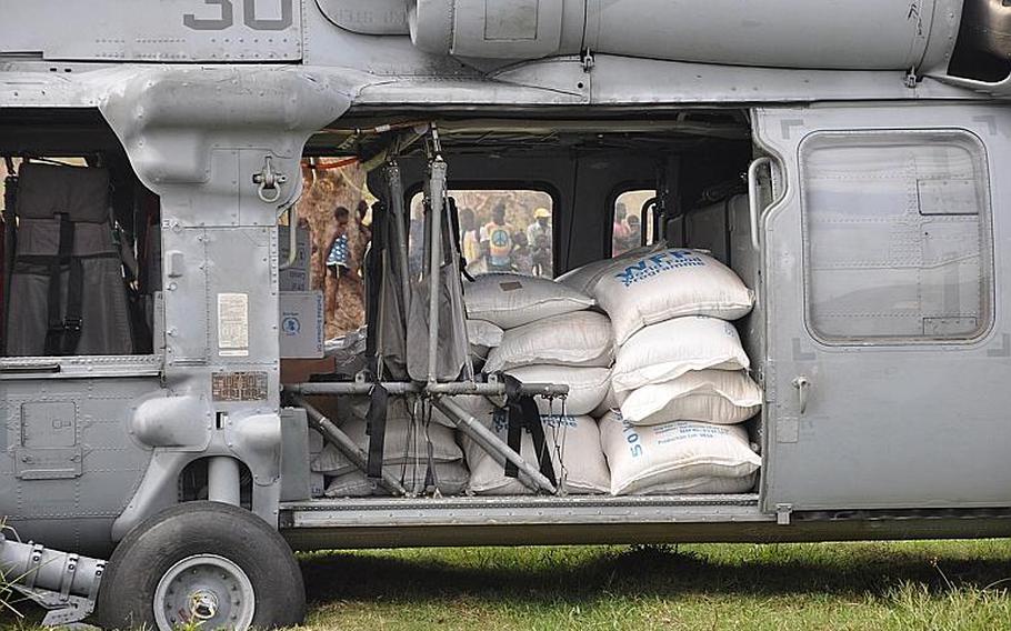A Navy helicopter delivers relief supplies to the village of Jabouin in southwest Haiti on Oct. 18. The village was badly hit by Hurricane Matthew two weeks ago, which destroyed homes and crops, leaving many people unsheltered and without food or livelihood.