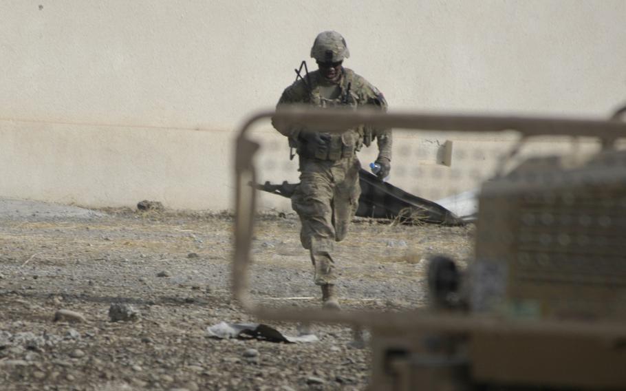 A U.S. soldier working east of Mosul, Iraq, runs after an explosion in a nearby village on Tuesday Nov. 1, 2016.