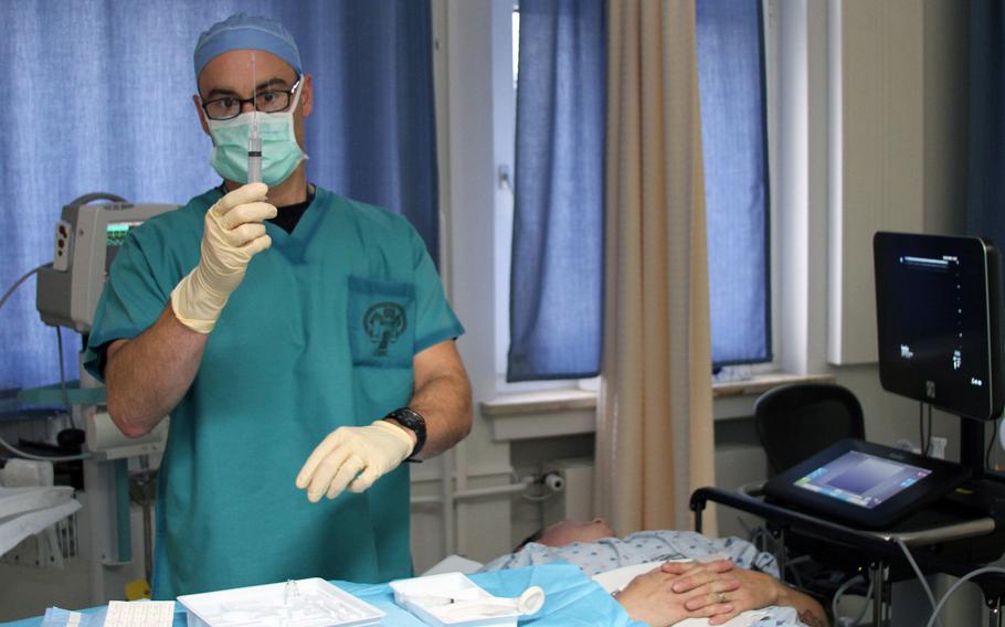Director of Landstuhl Regional Medical Center's Interdisciplinary Pain Management Center Dr. Jeffrey Tiede checks a syringe while preparing for a stellate ganglion block at LRMC on Oct. 24, 2016. This procedure involves injecting a local anesthetic into a patient's neck and often helps manage certain types of pain. A new study at LRMC is seeking patient volunteers to help determine if the stellate ganglion block can also address symptoms of Post Traumatic Stress Disorder.