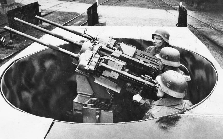 In this photo from the book "The Bombing of Wiesbaden, 1941-1945," by Thomas Weichel, German soldiers man anti-aircraft guns mounted on a truck in late 1944. After losing air superiority to the Allies, Germans increasingly turned to ground defenses to attempt to stop Allied bombings of cities such as Wiesbaden.