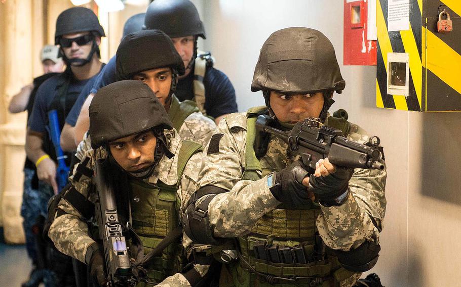 Visit, board, search, and seizure team members from the Indian Navy and the guided-missile cruiser USS Mobile Bay stack up in a passageway during joint training aboard the Indian Navy Deepak-class fleet tanker INS Shakti during Malabar 2016.