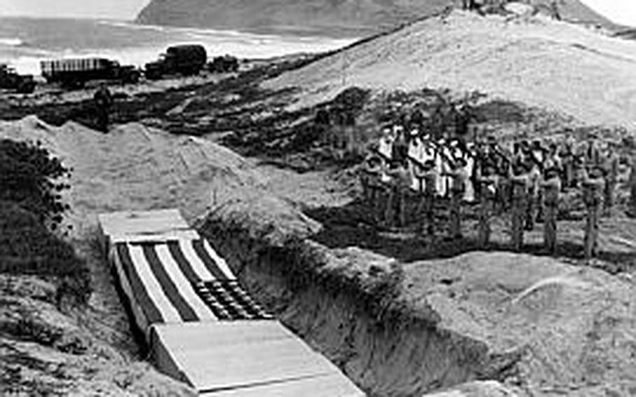 A Marine rifle squad fires a volley Dec. 8, 1941, over the bodies of 15 men killed at Naval Air Station Kanoehe Bay during the Pearl Harbor attack.