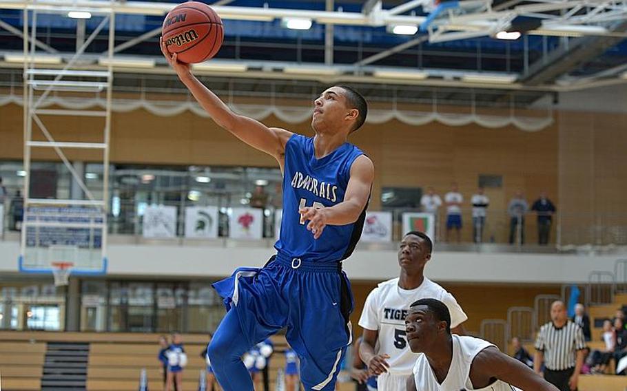 Rota's Jashaun Garrison glides to the basket past Hohenfels defenders in a Division II semifinal at the DOEA-Europe basketball championships in WIesbaden, Germany. Friday, Feb. 26, 2016. Michael Abrams/Stars and Stripes