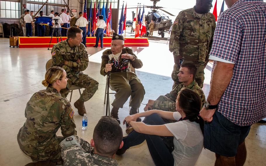 Joe Reilly, 95, relates stories of his service during World War II to soldiers stationed at Wheeler Army Airfield in Hawaii, after a remembrance ceremony, Monday, Dec. 5, 2016. The 1941 Japanese attack left 33 dead and 75 wounded at Wheeler, which was designated a National Historic Landmark in 1987.