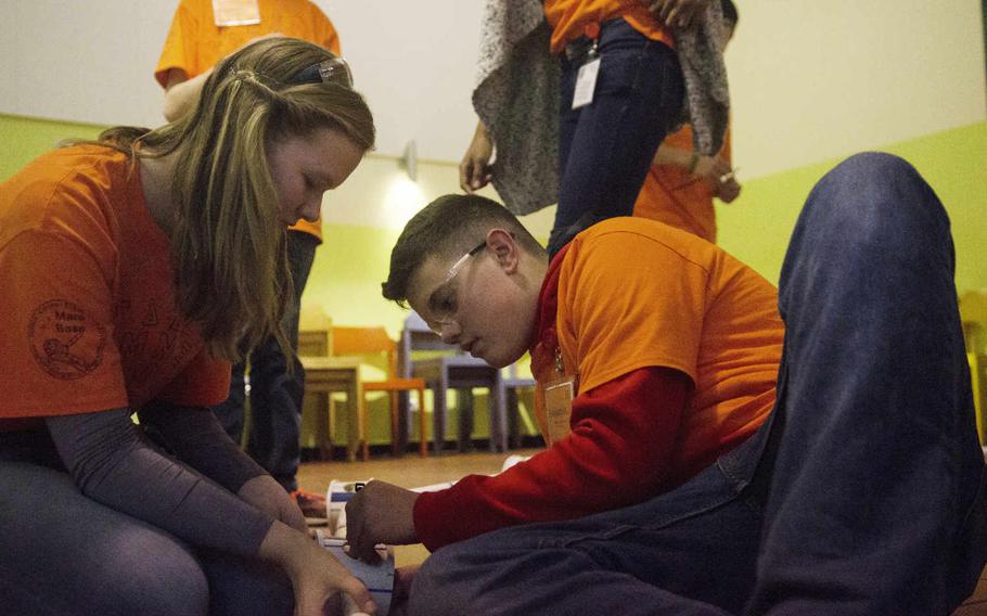 Construction "engineers" Dresden Goodwin, left, of Lakenheath High School, England, and Benjamin Blume of Vilseck High School, Germany, assemble a geodesic dome - part of their task in developing a colony on Mars during the STEMposium, Tuesday, Dec. 6, 2016, in Wiesbaden, Germany. STEMposium is a weeklong science, math and engineering symposium for students in the Defense Department's schools in Europe.