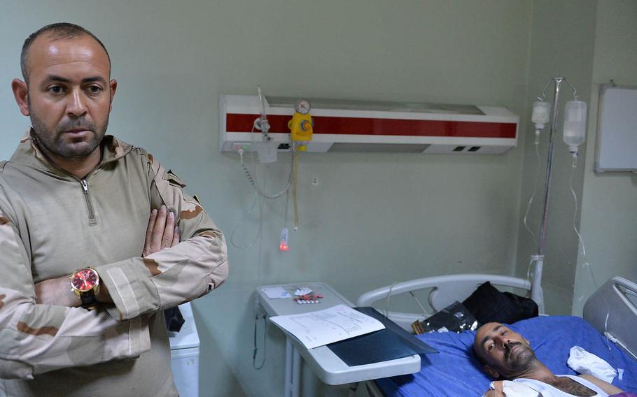 Mohammed Sbuh Saud, left, was accompanying his brother Fars Sbuh Saud, right, during his treatment at the West Irbil Emergency Hospital on Sunday, Nov. 20, 2016. The brothers are both soldiers in the Iraqi army's 16th Division. Fars Sbuh Saud was injured in a mortar attack in the Mosul suburb of Gogjali three days earlier.