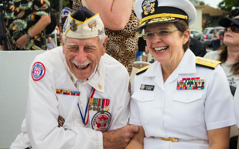 Delton E. Walling, a Pearl Harbor attack survivor and former sailor on the USS Pennsylvania, shares a laugh with Rear Adm. Margaret Kibben, the Navy's chief of chaplains, before a ceremony honoring the crew of the USS Utah, Dec. 6, 2016, on Ford Island, Hawaii. A torpedo attack destroyed the ship, killing 64 men, and the sunken wreck remains at the bottom of Pear Harbor.