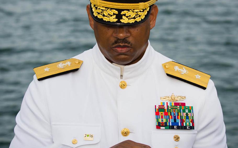 Rear Adm. John Fuller, commander of Navy Region Hawaii, holds an urn containing the cremated remains of John Anderson during a ceremony Dec. 7, 2016, at the USS Arizona Memorial. Anderson survived the 1941 attack on the Arizona, and chose to have his ashes interred in the submerged ship.