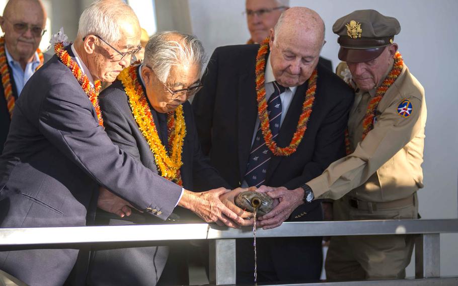 From left: Shiro Wakita, former World War II Imperial Japanese Navy pilot; Hiroya Sugano, director general of the Zero Fighter Admirers Club; Jack Detour, former colonel and WWII Army Air Force B-25 pilot; and Jerry Yellin, former captain and WWII Army Air Force P-51 pilot, pour bourbon into Pearl Harbor during the sixth-annual Blackened Canteen ceremony at the USS Arizona Memorial, Dec. 6, 2016. The canteen is a relic from an air raid over Shizauoka, Japan, in 1945, and the bourbon represents an offering to the fallen in the waters of Pearl Harbor.