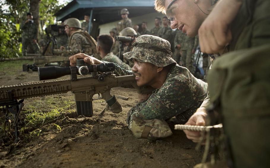 Marine Cpl. Alec Milejczak shows a Philippine Marine how to use an M110 semi-automatic sniper system during Philippine Amphibious Landing Exercise 33 at Colonel Ernesto Ravina Air Base, Philippines, Oct. 7, 2016. The allies have canceled next year's PHIBLEX.