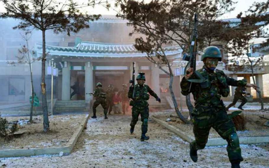 This screenshot from an image in North Korea's Rodong Sinmun newspaper purports to show a mock attack being carried out on a replica of South Korea's presidential residence known as the Blue House.