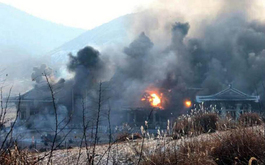This screenshot from an image in North Korea's Rodong Sinmun newspaper purports to show a mock attack being carried out on a replica of South Korea's presidential residence known as the Blue House.