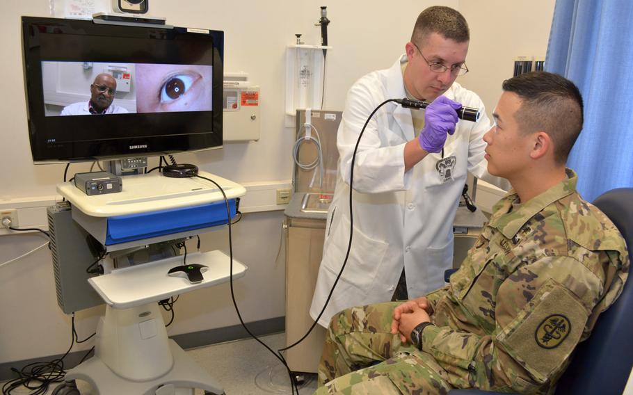 Sgt. 1st Class Todd Hall, in charge of telehealth for Regional Health Command Europe, demonstrates the virtual eye exam on 1st Lt. Alexander Cho on May 31, 2016. Virtual health is the use of electronic information, imaging, and communication technologies to provide health care when distance separates the patient and the provider.