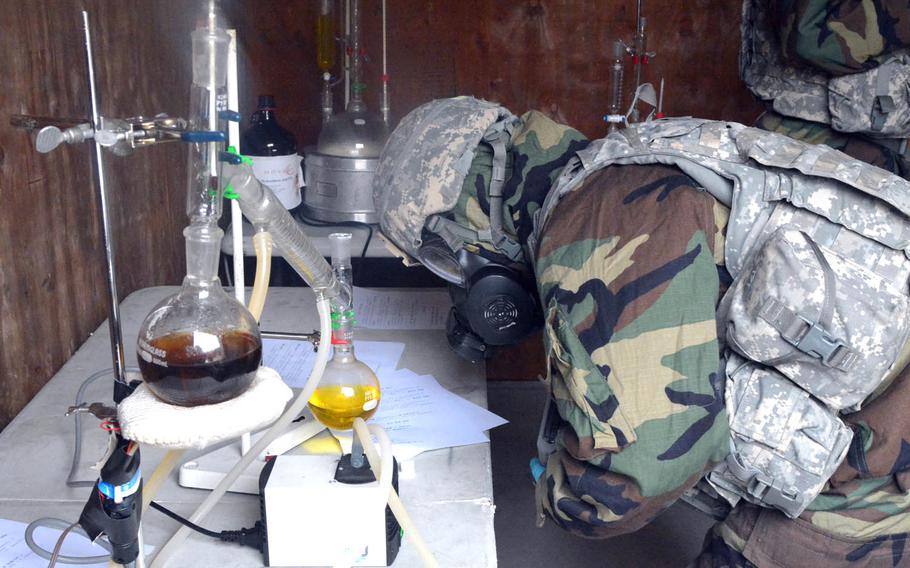 A soldier with the 501st CBRNE Company examines a mock chemical weapons laboratory during a drill at Rodriguez Live Fire Range, South Korea, Wednesday, Dec. 7, 2016. The exercise was held with the Fort Riley, Kan.-based 3rd Battalion, 66th Armored Regiment, 1st Armored Brigade Combat Team, 1st Infantry Division, as part of training to increase the readiness of troops to confront threat of chemical and biological weapons and nuclear weapons.