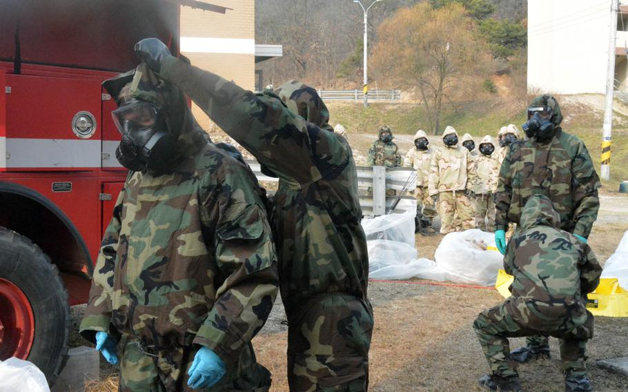 Soldiers with the 501st CBRNE Company and the Fort Riley, Kan.-based 3rd Battalion, 66th Armored Regiment, 1st Armored Brigade Combat Team, 1st Infantry Division undergo decontamination after clearing buildings and finding a mock chemical weapons laboratory during a drill at Rodriguez Live Fire Range, South Korea, Wednesday, Dec. 7, 2016.