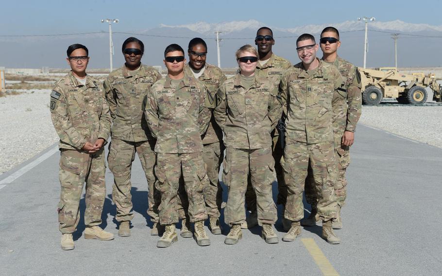 Members of the sling load detachment at Bagram Air Field, Afghanistan, take a break from work, Dec. 5, 2016. From left, Staff Sgt. Carlo Sablan, Spc. Mikeal Bailey, Spc. Michael Colombe, Spc. Kreshonna Conyers, Pfc. Sarah Reschke, Cpl. Marcel Woods, Capt. Brendan Kasony and Spc. Eugene Lee.